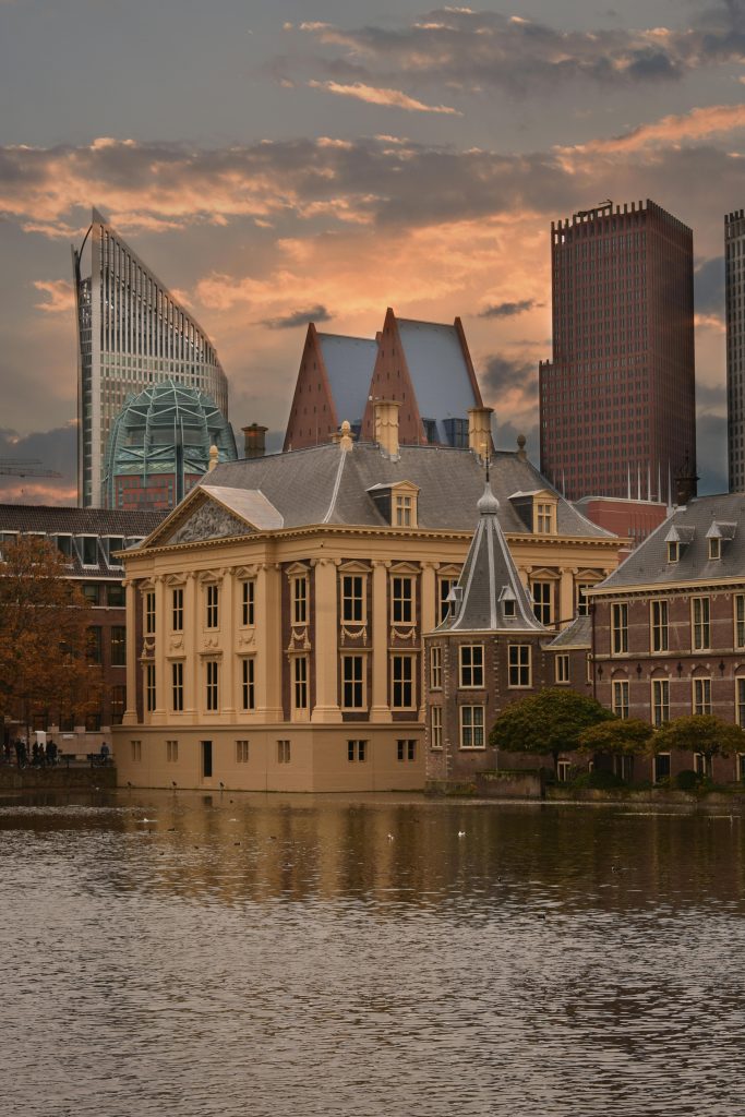 Captivating sunset view of the Mauritshuis Museum in The Hague with modern skyline.