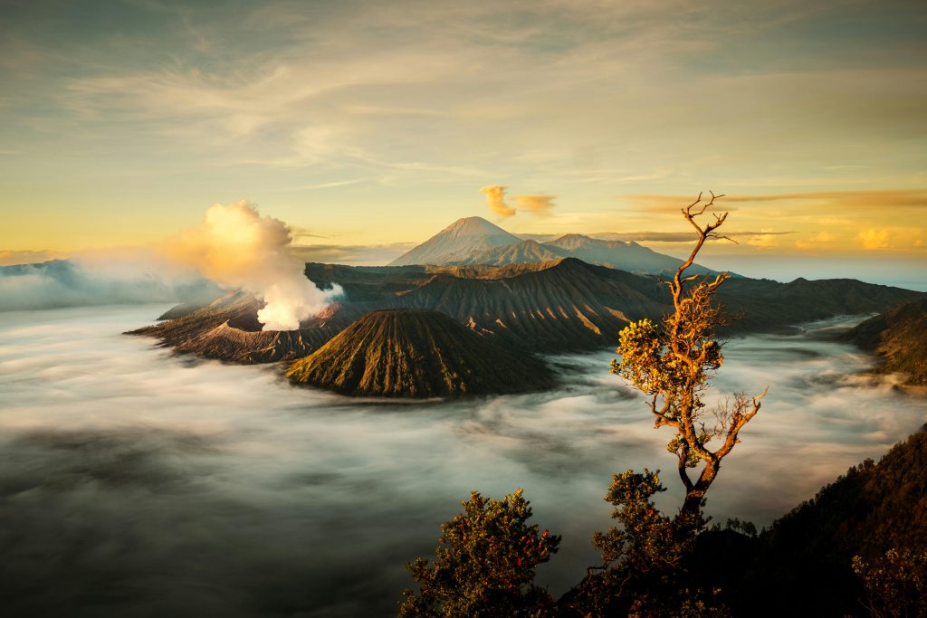 Breathtaking view of Mount Bromo shrouded in mist during sunrise in Jawa Tengah, Indonesia.